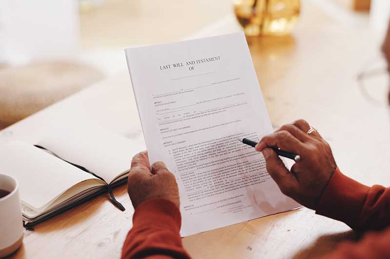 probate and estate attorney massachusetts - Hands, person and document for will at house with pen, information or reading in morning.