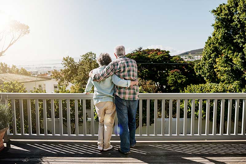 setting up a trust - Morning, balcony and back of senior couple hug