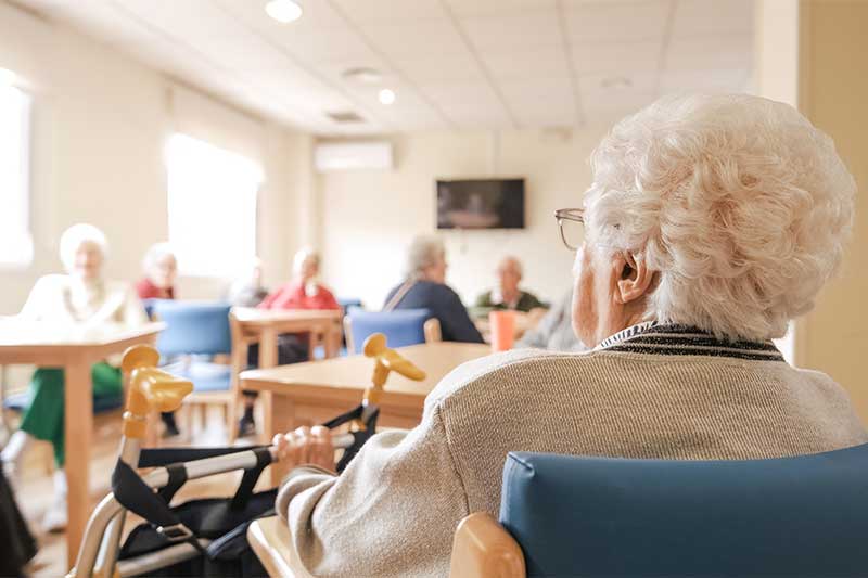 how do i get power of attorney - Photo description: Elderly woman with foldable walker in nursing home