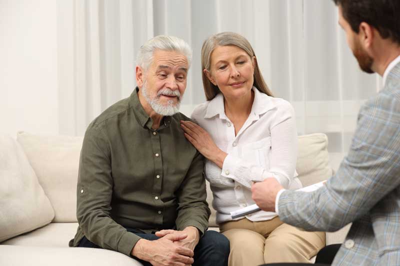 probate administration attorney massachusetts - Photo description: attorney onsulting senior couple about Last Will and Testament in office